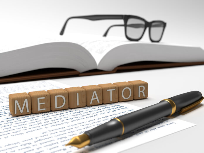 Mediator - dices containing the word mediator, a book, glasses and a fountain pen.