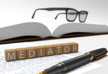 Mediator - dices containing the word mediator, a book, glasses and a fountain pen.