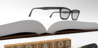 Mediator - dices containing the word mediator, a book, glasses and a fountain pen.